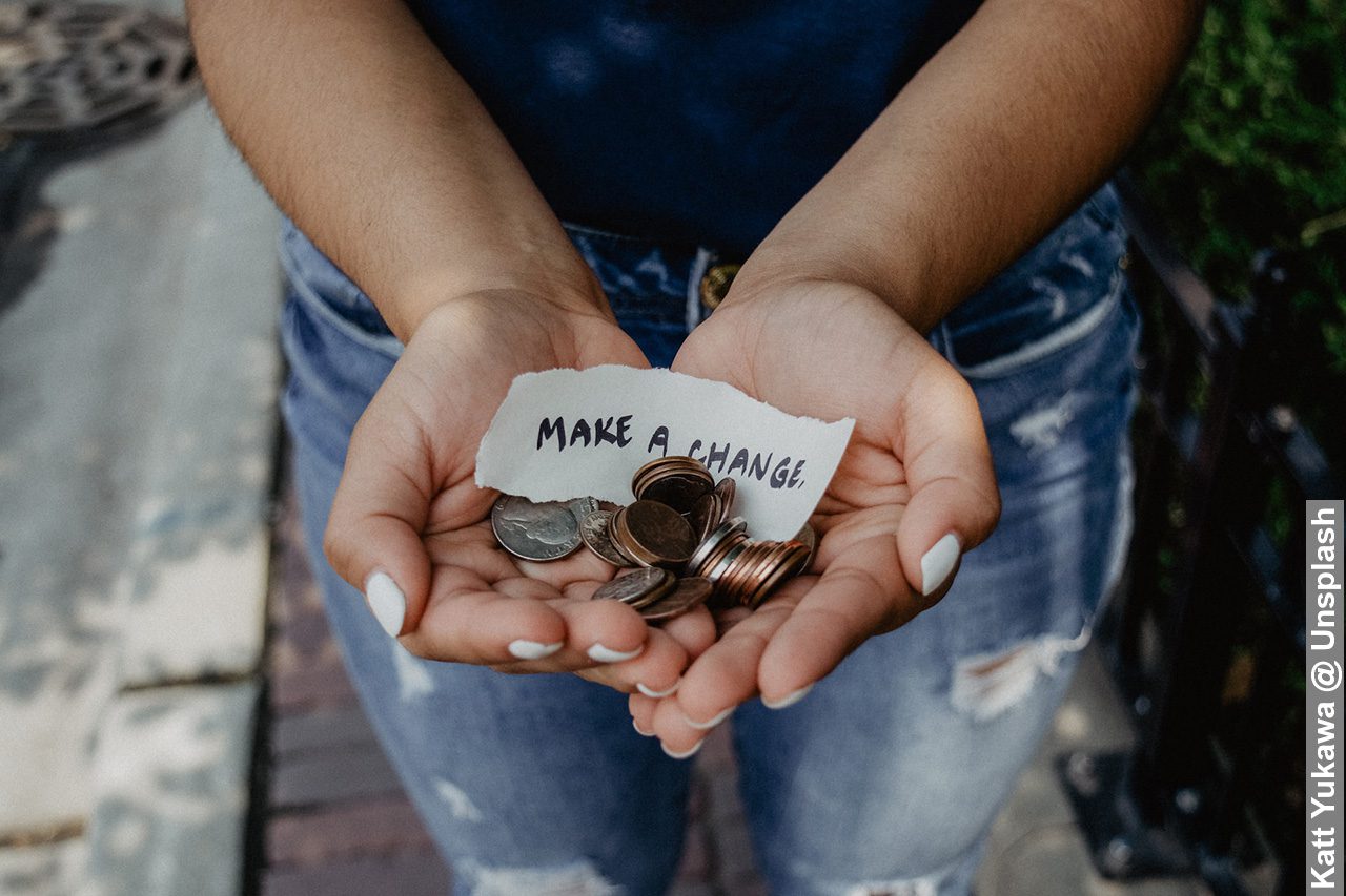 Female hands with make a change note and coins in palms