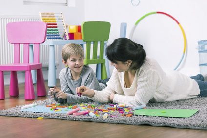 Pushy parents; mum and son having fun together learning