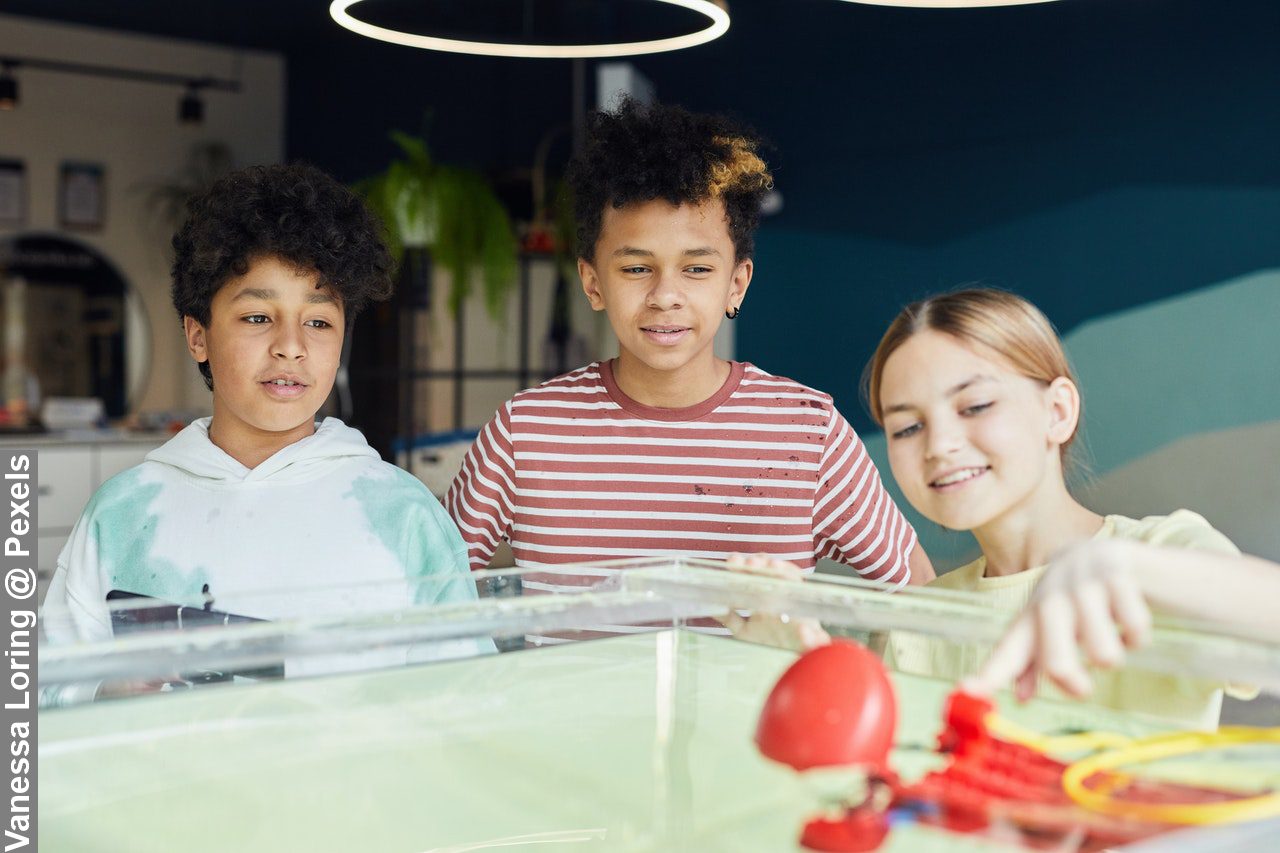 Build A Level 5 Child: Kids playing with robot in class