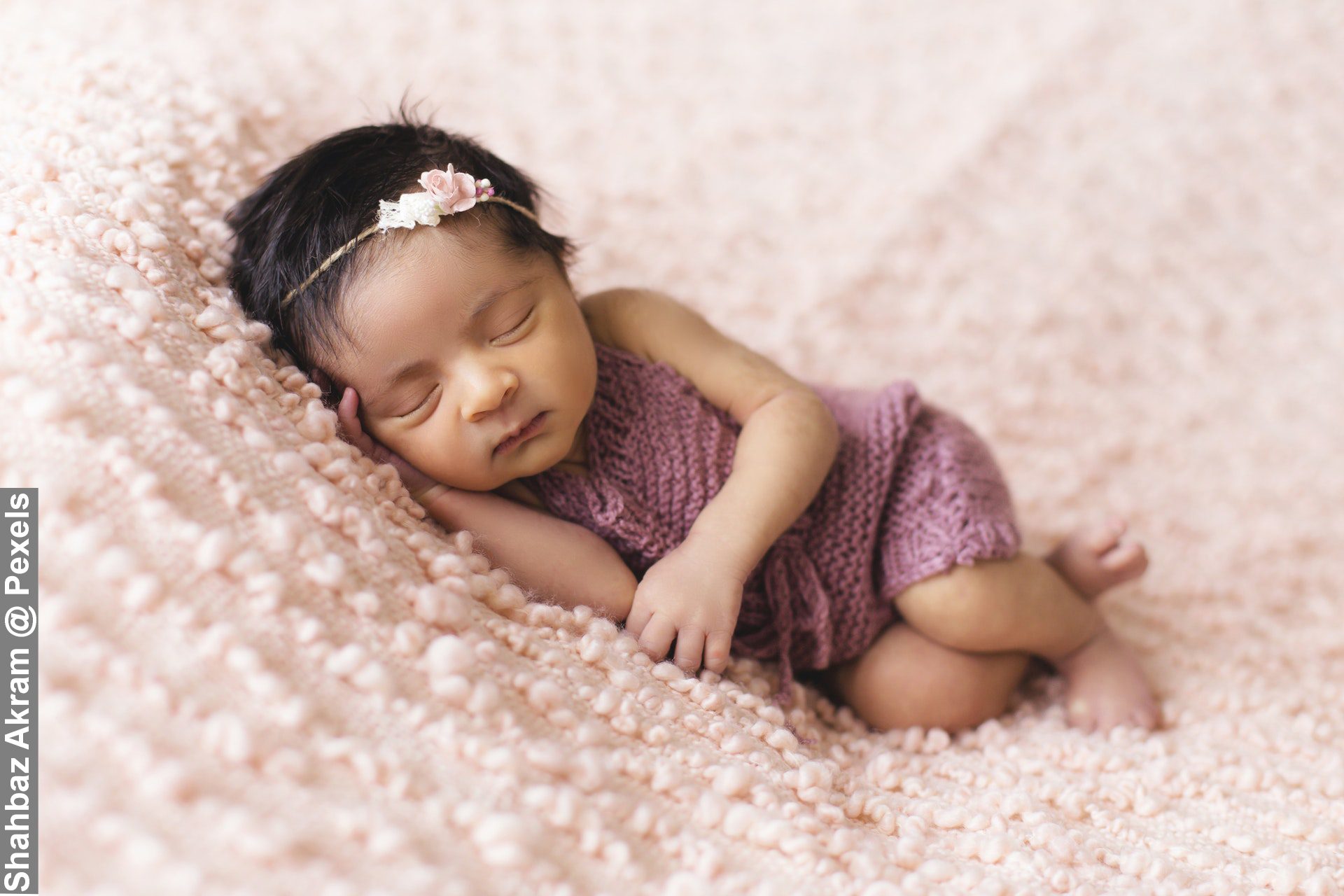 Toddler Sleeping on Pink Fleece Bed