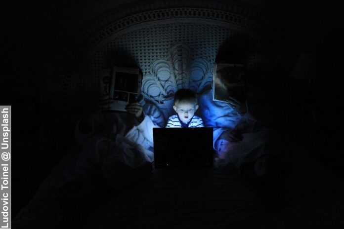 A small geek, hacker boy addicted to the screen