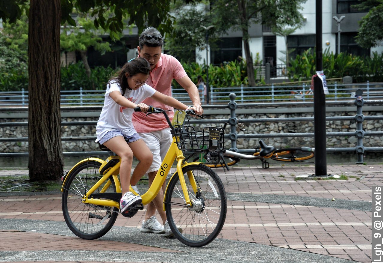 Why Father’s Day 2022 is important, dad wit daughter teaching her how to ride bike