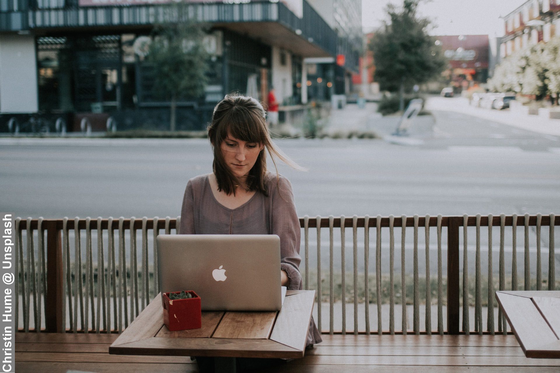 Lady with unique working routines working on street desk as she goes