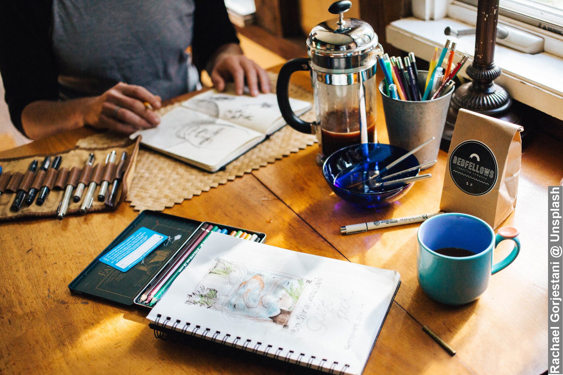 Unique working routines and environment man sitting on desk looking at sketches