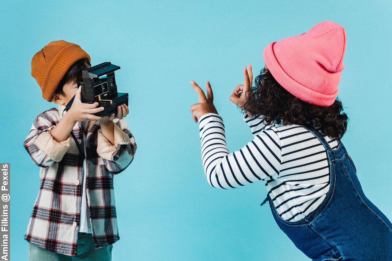 Family photography Positive children taking photo on instant photo camera