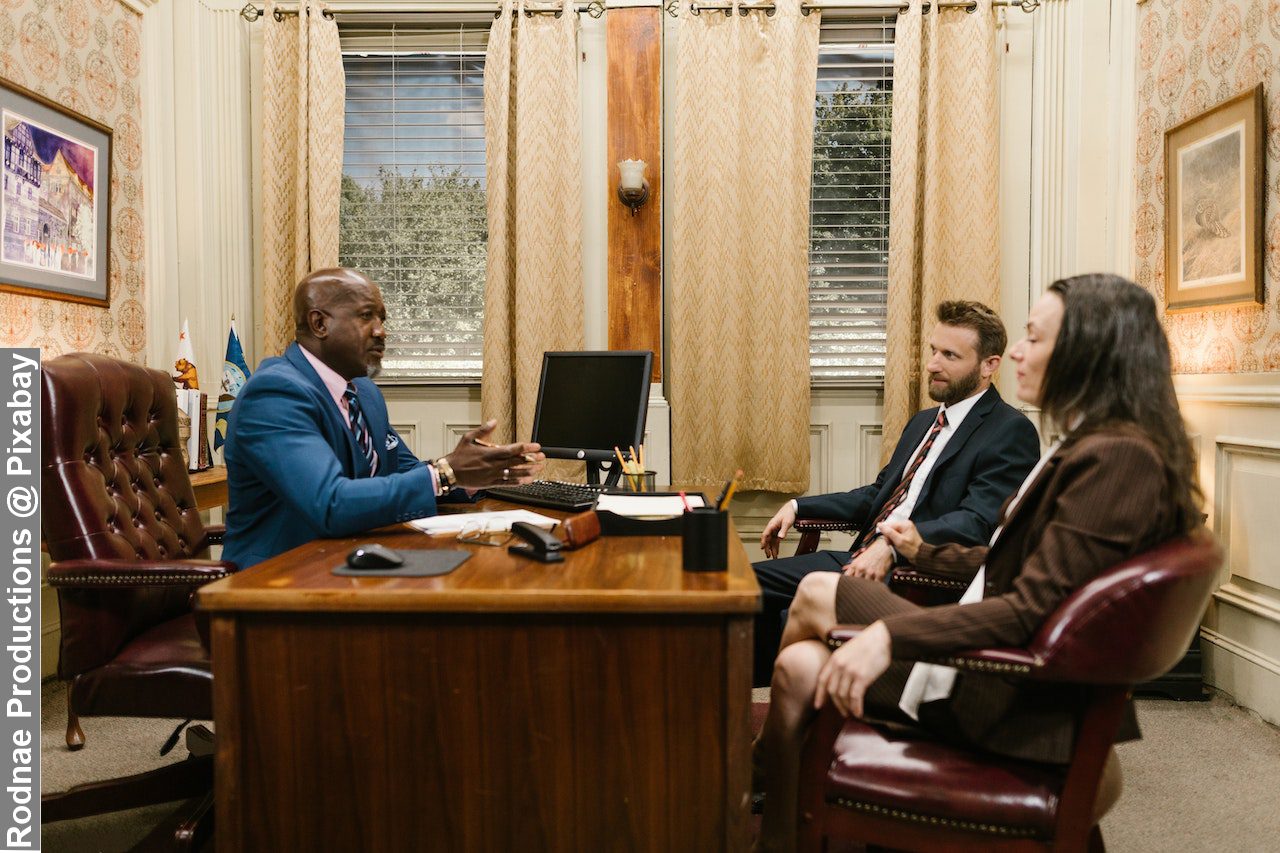 Husband and wife having a meeting inside divorce lawyer office