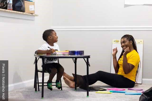 Role of a mother, teaching son at home in a happy environment