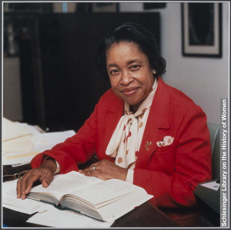 Margaret Walker Sitting at table signing books