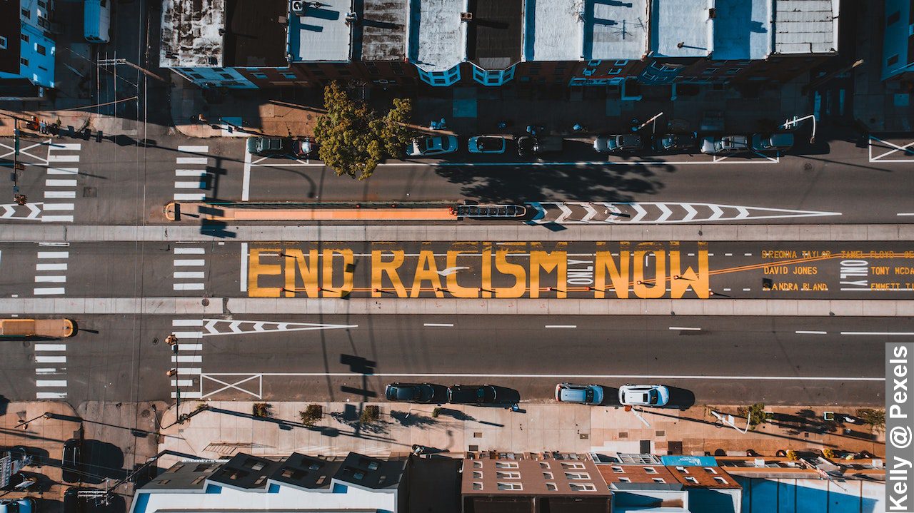 Roadway with END RACISM NOW title in town fight against racial intolerance