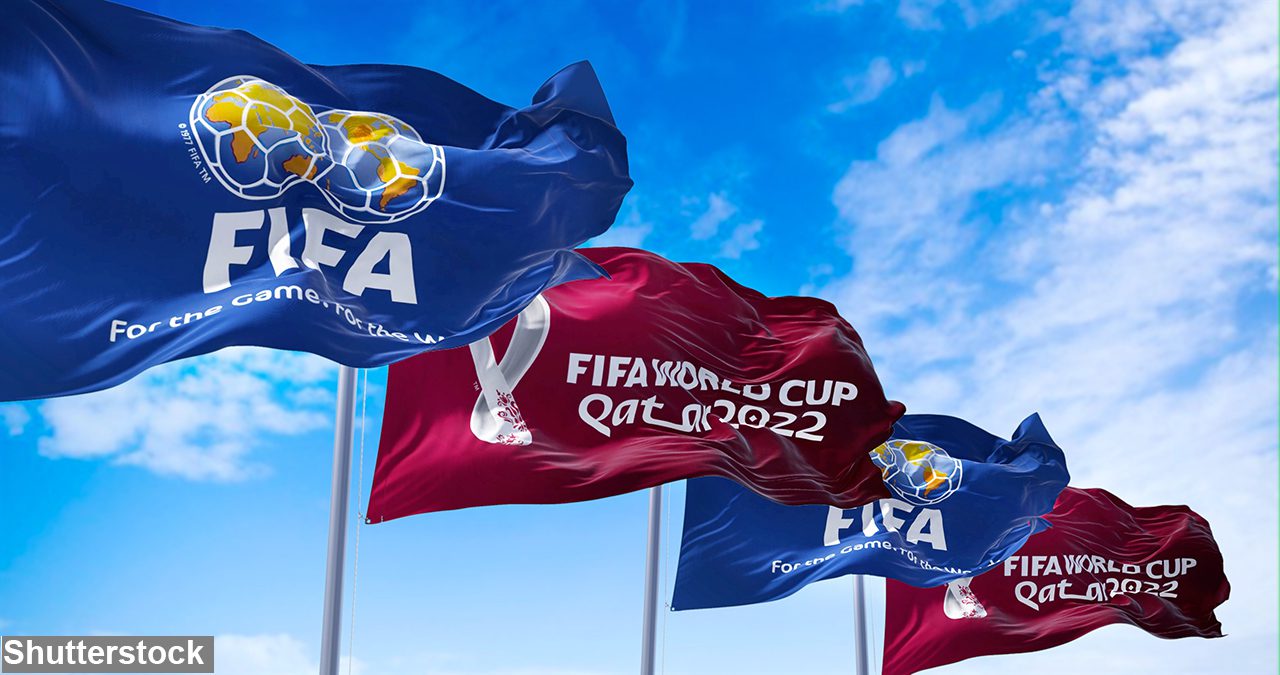 lags with FIFA and Qatar 2022 World Cup logo waving in the wind