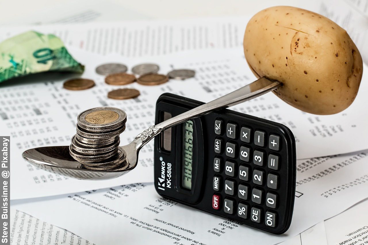 Household budget money with coins and calculator balancing