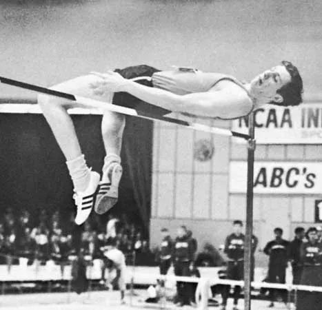 Image of Dick Fosbury in black and white, flying over the high jump bar